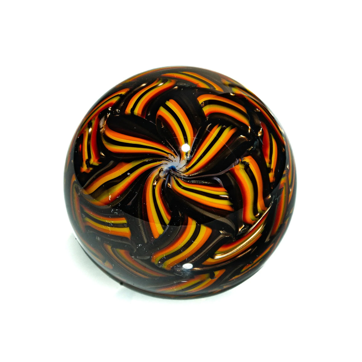 Handblown glass marble with vibrant orange, yellow, and black swirling patterns