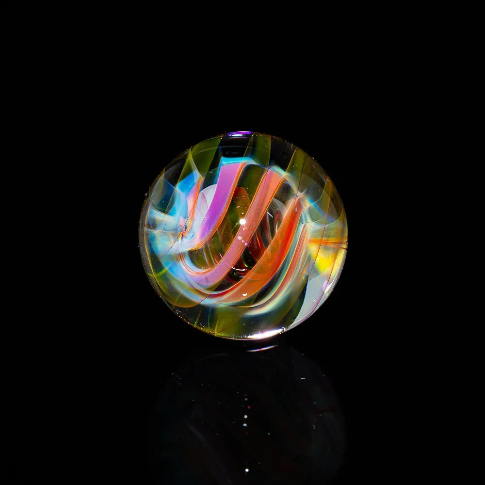 Heady glass marble with vibrant rainbow swirl design on black background