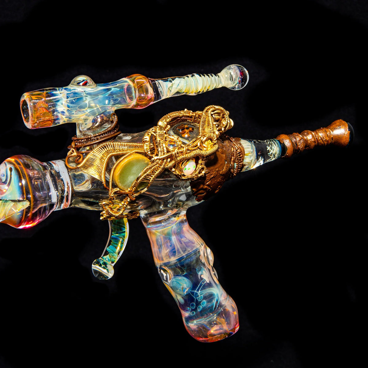 Heady glass art pipe shaped like a ray gun with intricate wire and gemstone detailing