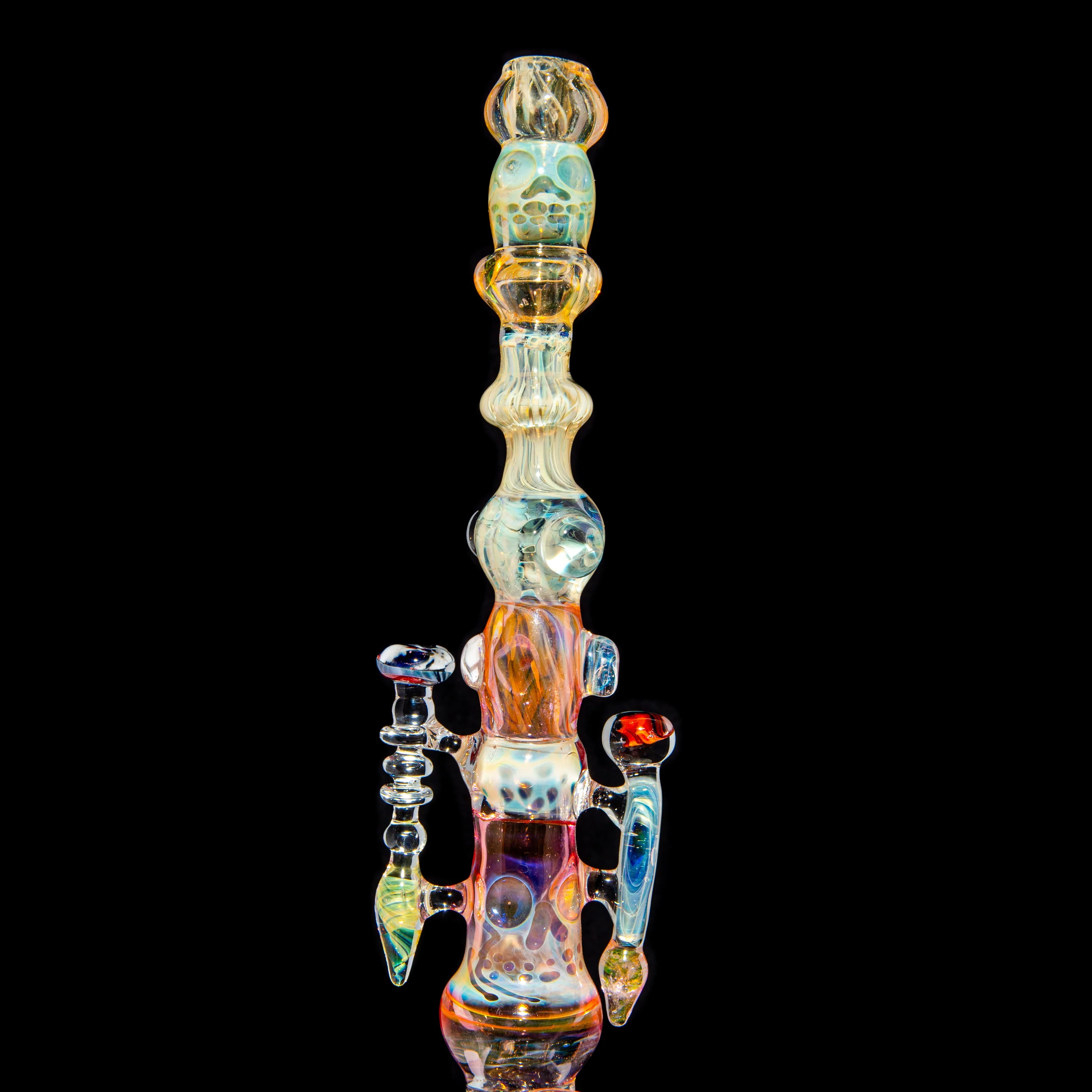 Colorful heady glass water pipe with intricate details on black background