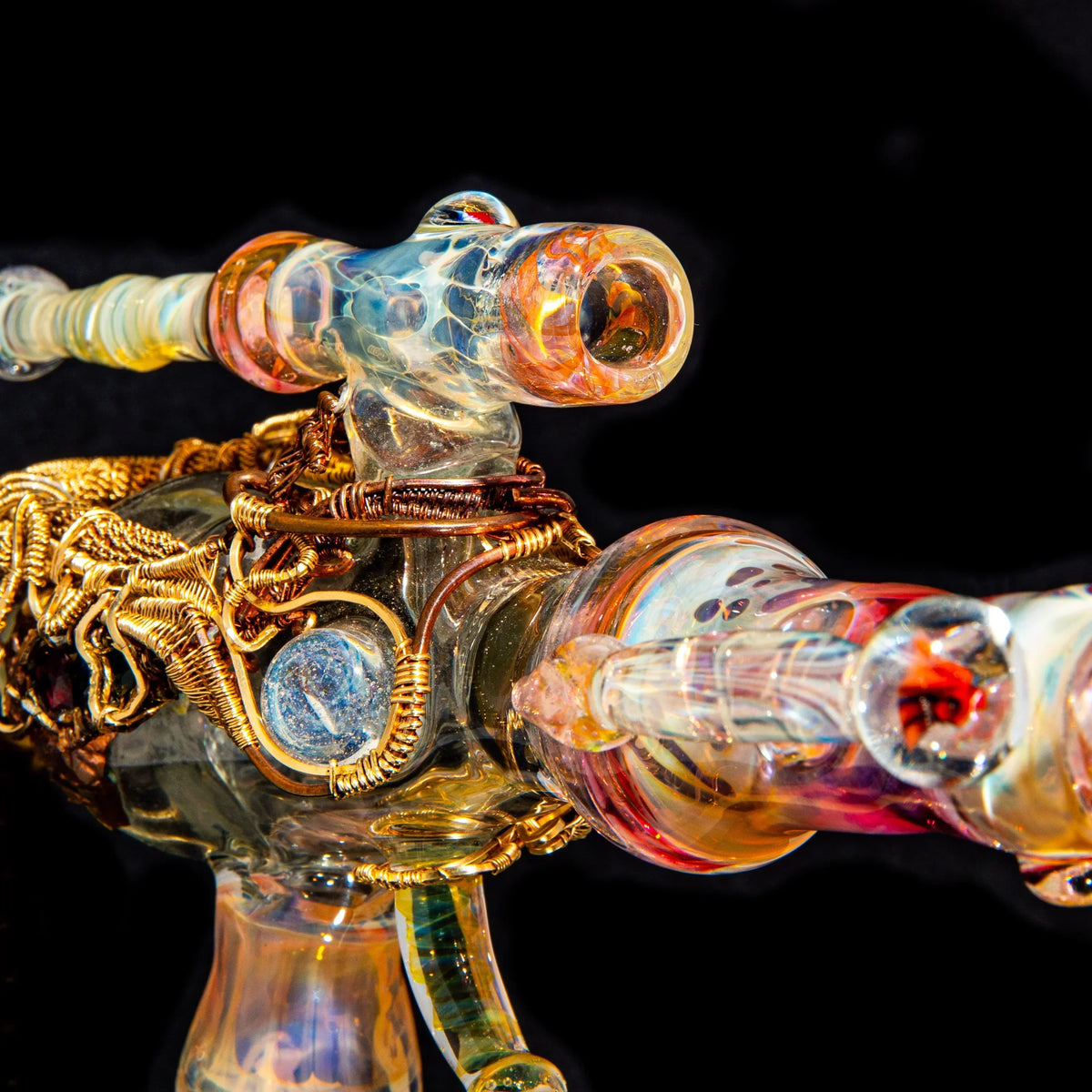 Heady glass pipe with colorful swirls and intricate wire wrapping against a black background