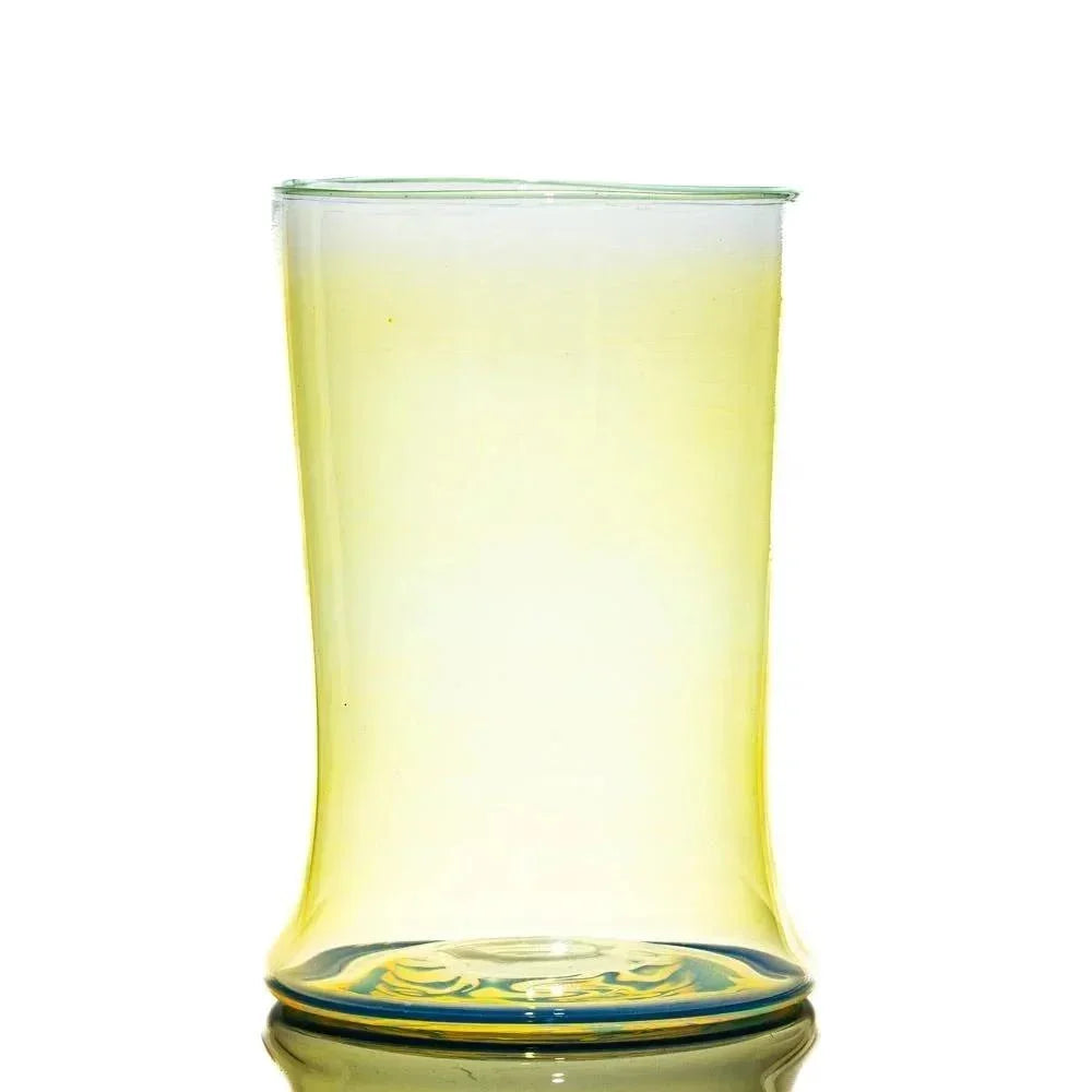 Translucent yellow glass tumbler with subtle blue accent base on white background