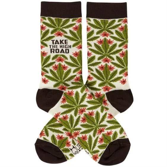 Crew socks with green leaf and red flower pattern, text 'Take the High Road' on white background.