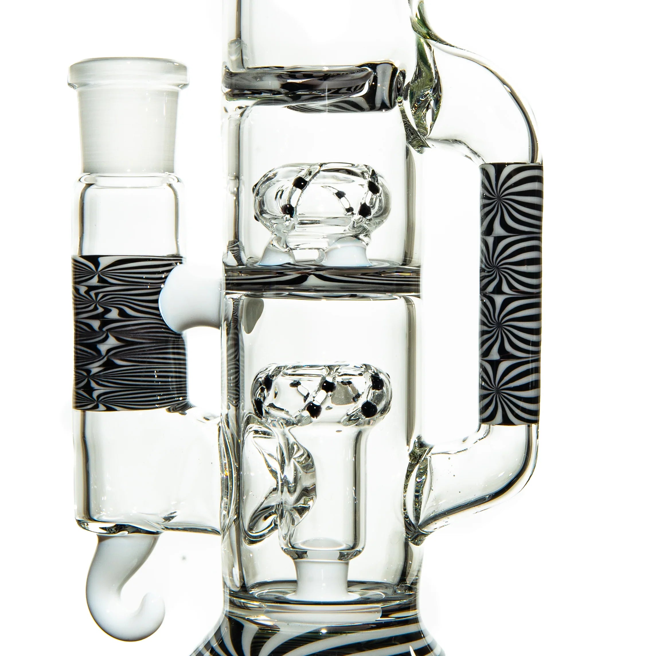 Clear glass water pipe with intricate percolators and black and white patterned accents