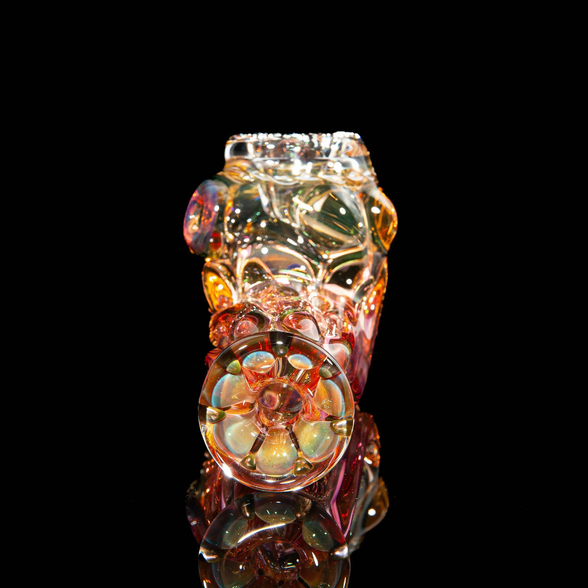 Heady glass pipe with intricate colors and patterns on black background, art glass smoking accessory