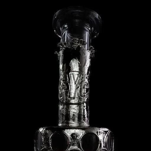Close-up of a clear, intricately designed glass water pipe on a black background