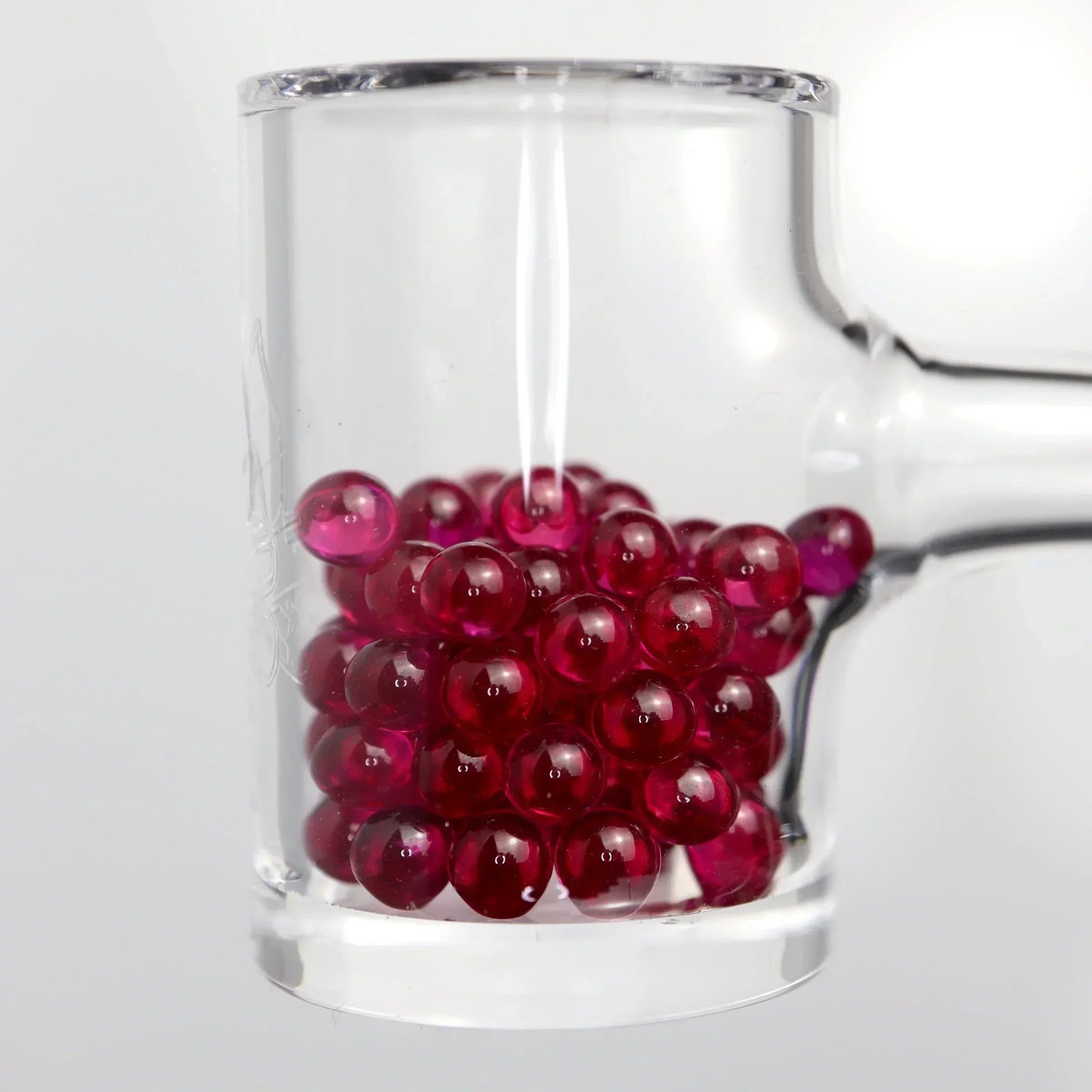 Clear quartz banger filled with red terp pearls for concentrate vaporizer accessories