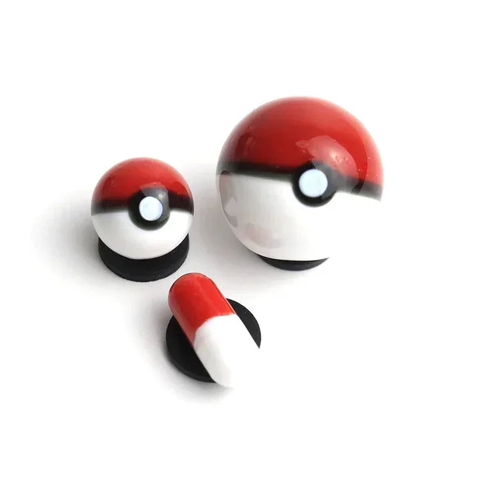 Set of red and white glass carb caps and a dab tool on a white background