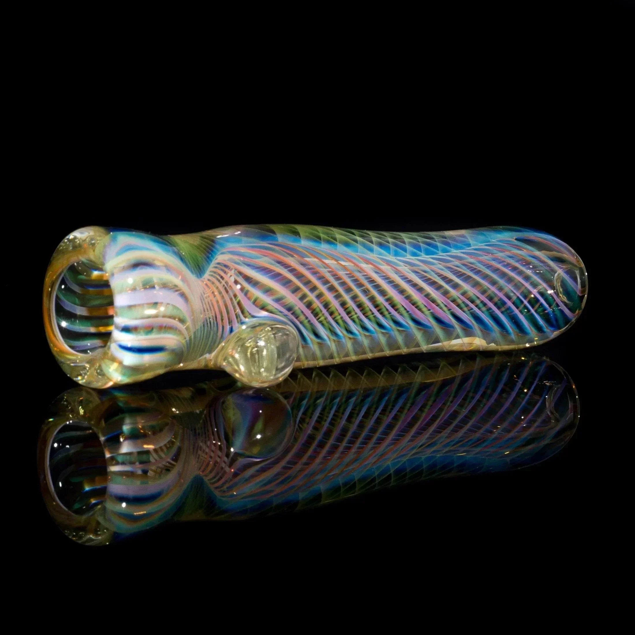Colorful handcrafted glass hand pipe with swirling patterns on a reflective black background