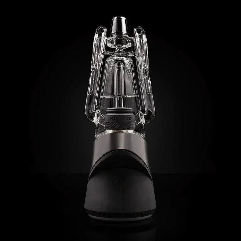Modern glass and metal vaporizer with clear water filtration attachment on black background