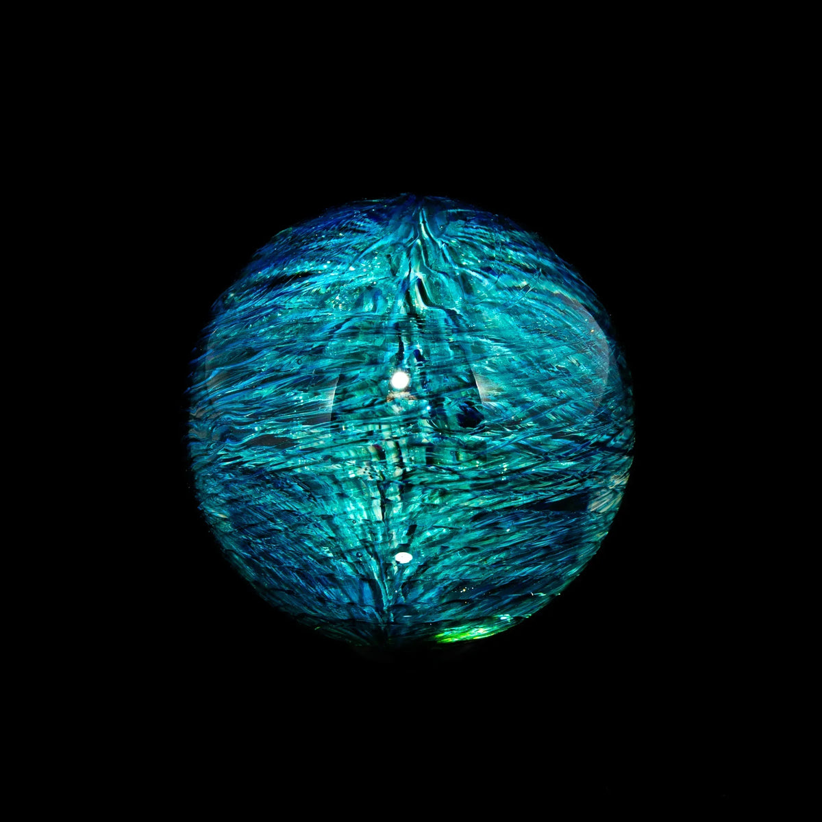 Blue swirling heady glass marble with textured patterns on black background
