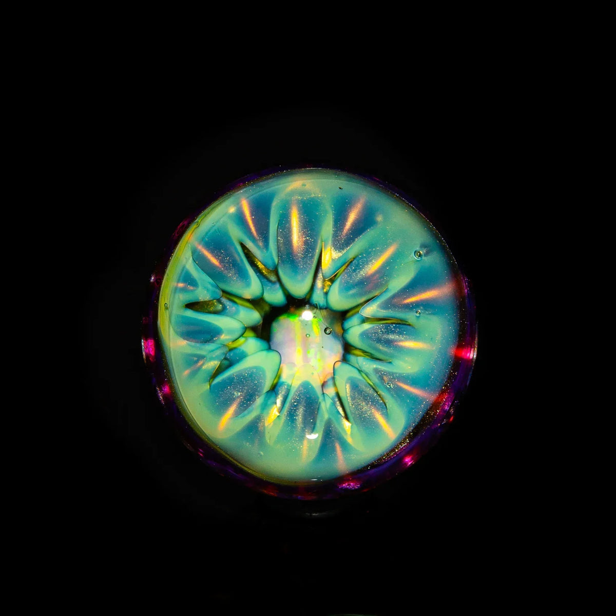 Colorful glass art pendant with iridescent, jellyfish-like design on black background