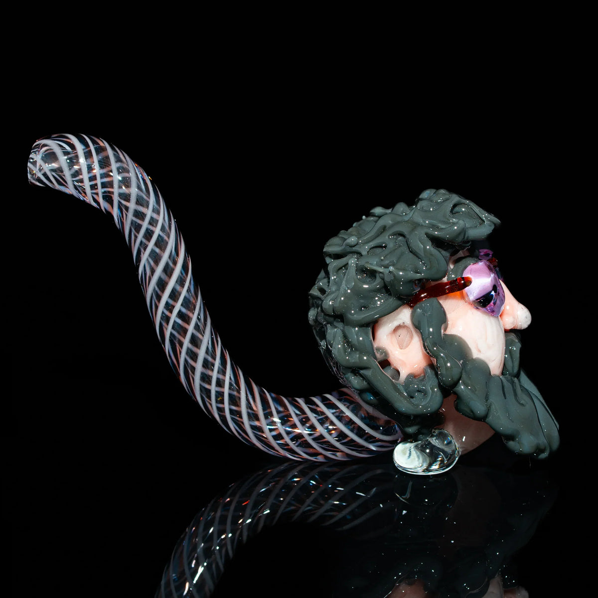Handcrafted glass pipe with twisted stem and a sculpted bearded face wearing sunglasses
