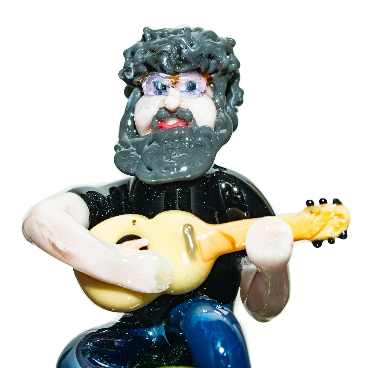 Handcrafted glass art figure of a bearded man playing guitar, detailed lampwork sculpture