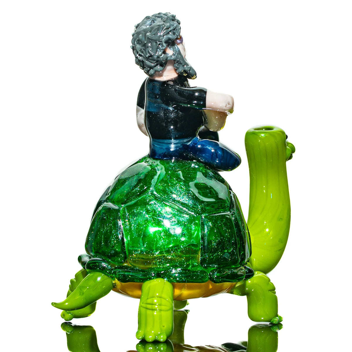 Handmade glass pipe shaped like a man riding a green turtle, detailed and colorful design