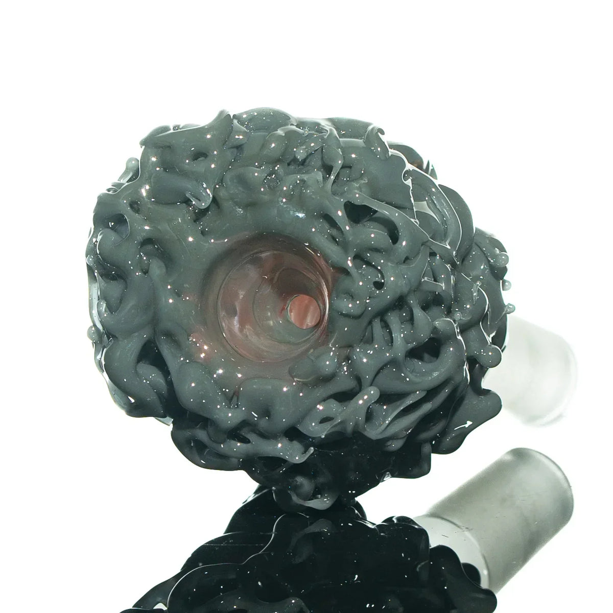 Close-up of intricate gray glass slide accessory with textured, artistic design for water pipes