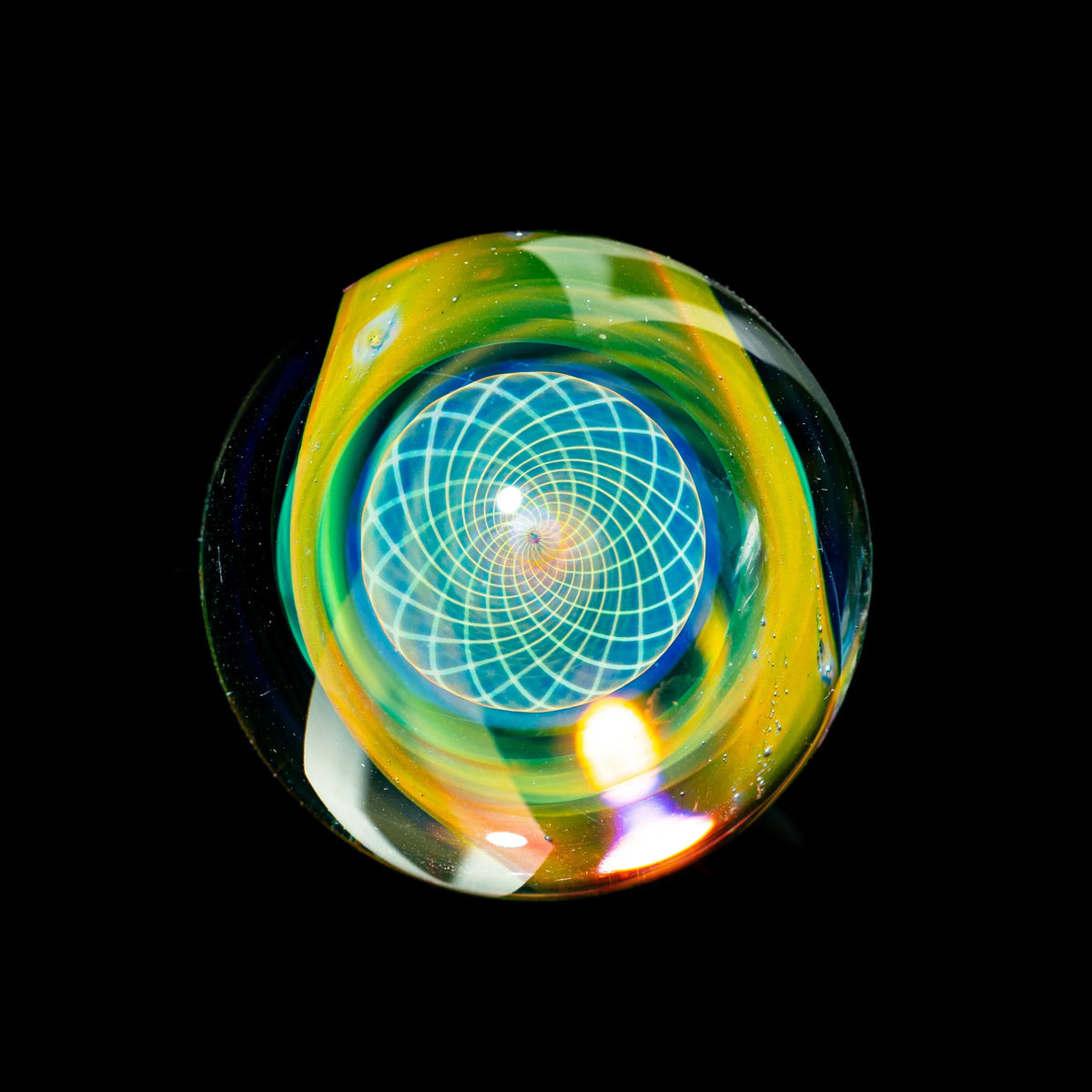 Heady glass marble with vibrant colors and geometric spiral pattern on black background