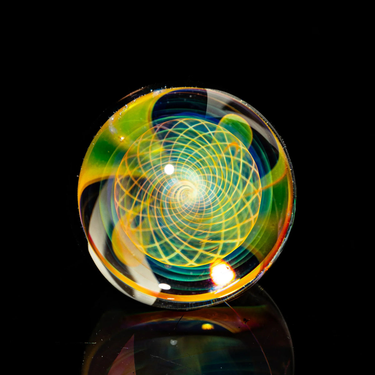 Colorful glass marble with intricate spiral pattern, artisan glass art on black background