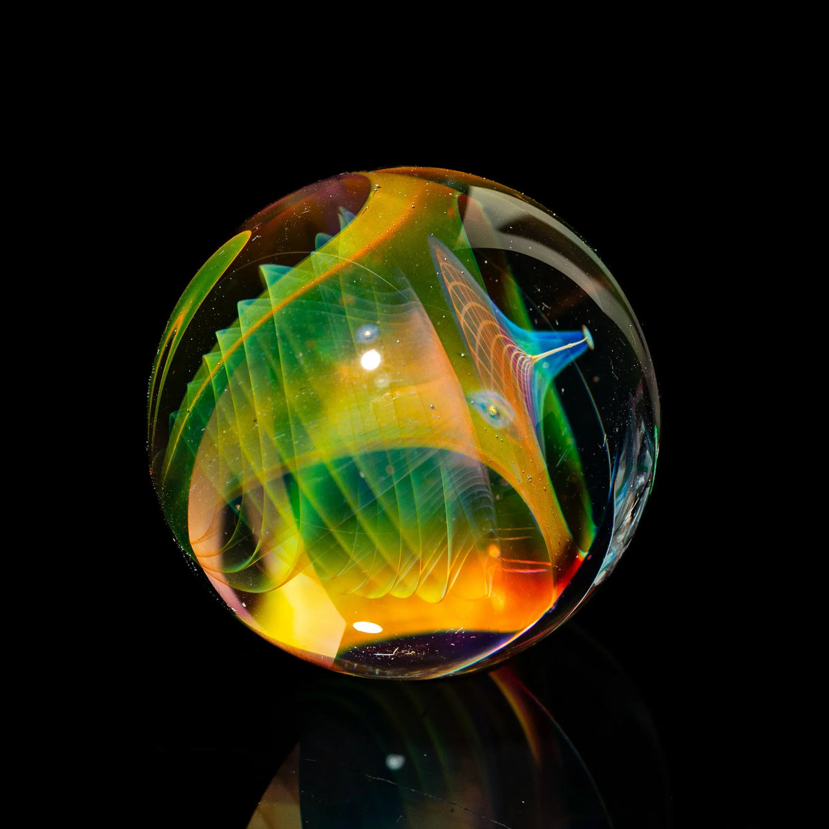 Handcrafted glass marble with vibrant rainbow patterns and intricate details on black background