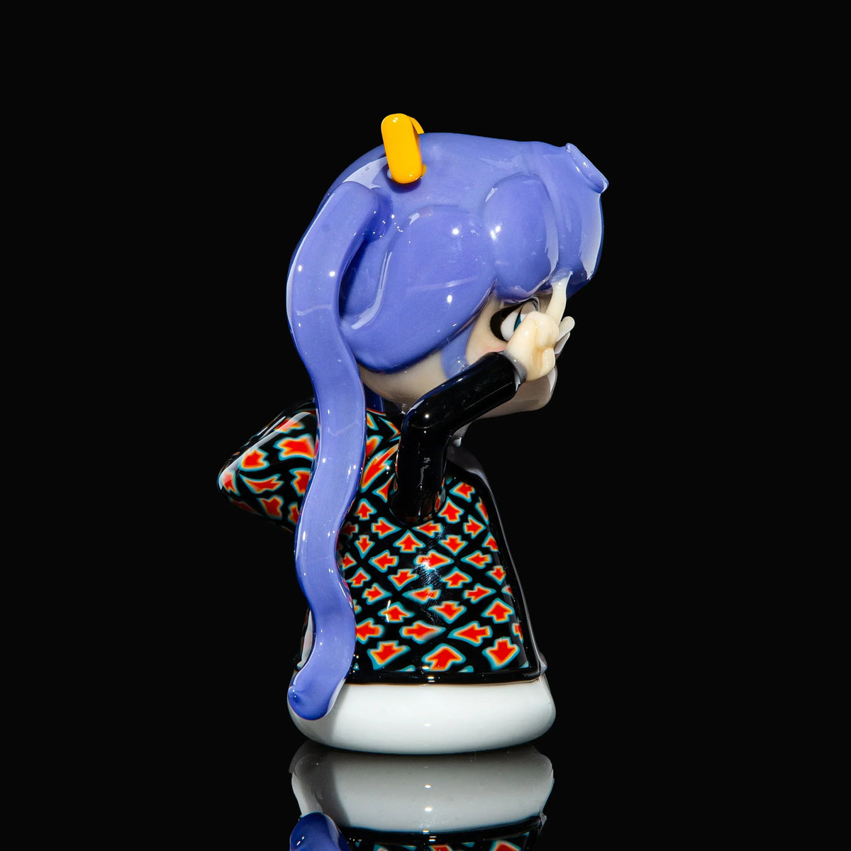 Handcrafted glass art piece of an anime figure with purple hair and patterned clothes