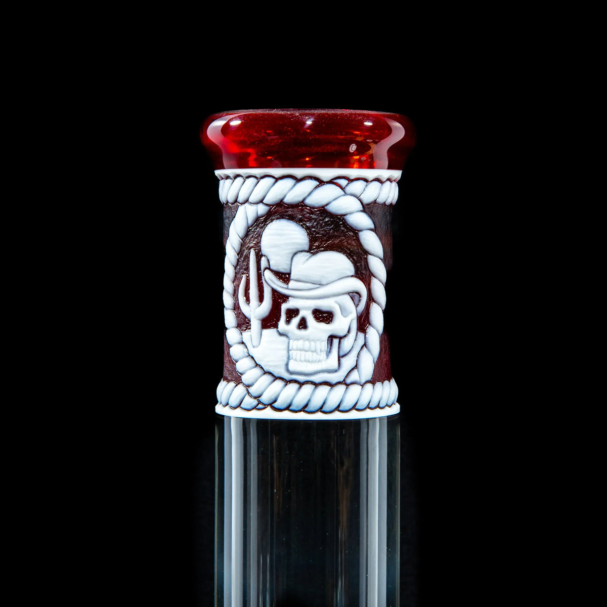 Red and clear glass pipe with cowboy skull and rope design, smoking accessory