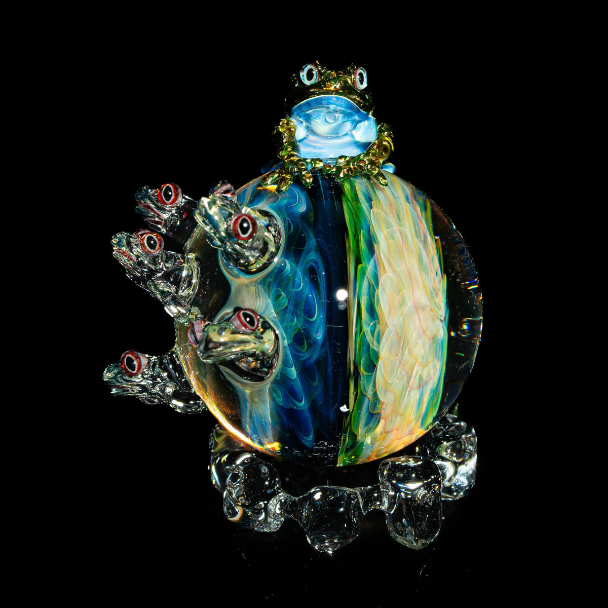 Hand-blown glass art sculpture with colorful swirls and detailed frog figures