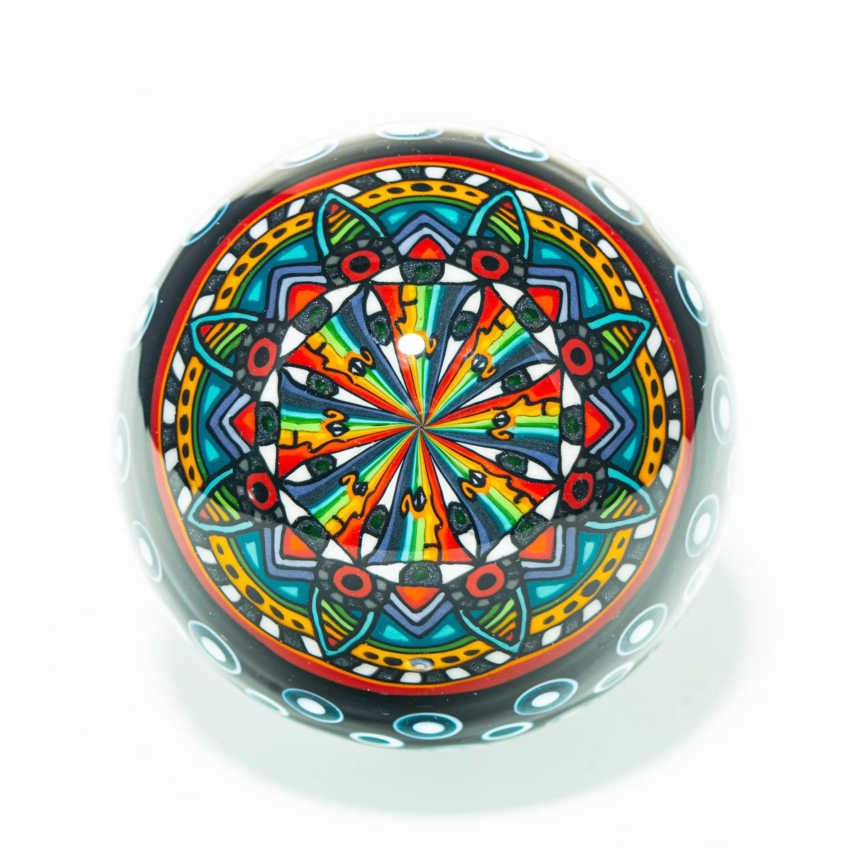 Colorful glass marble featuring intricate mandala pattern, heady glass art accessory.
