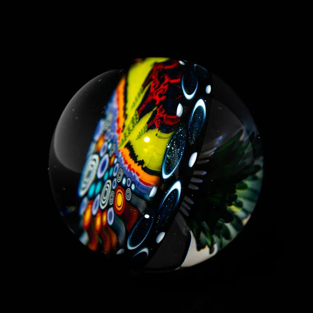 Hand-blown glass marble with vibrant, psychedelic patterns and intricate designs