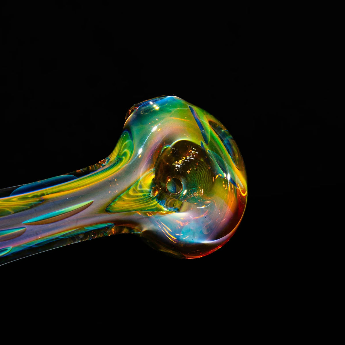 Colorful handblown glass pipe with vibrant swirls on a black background