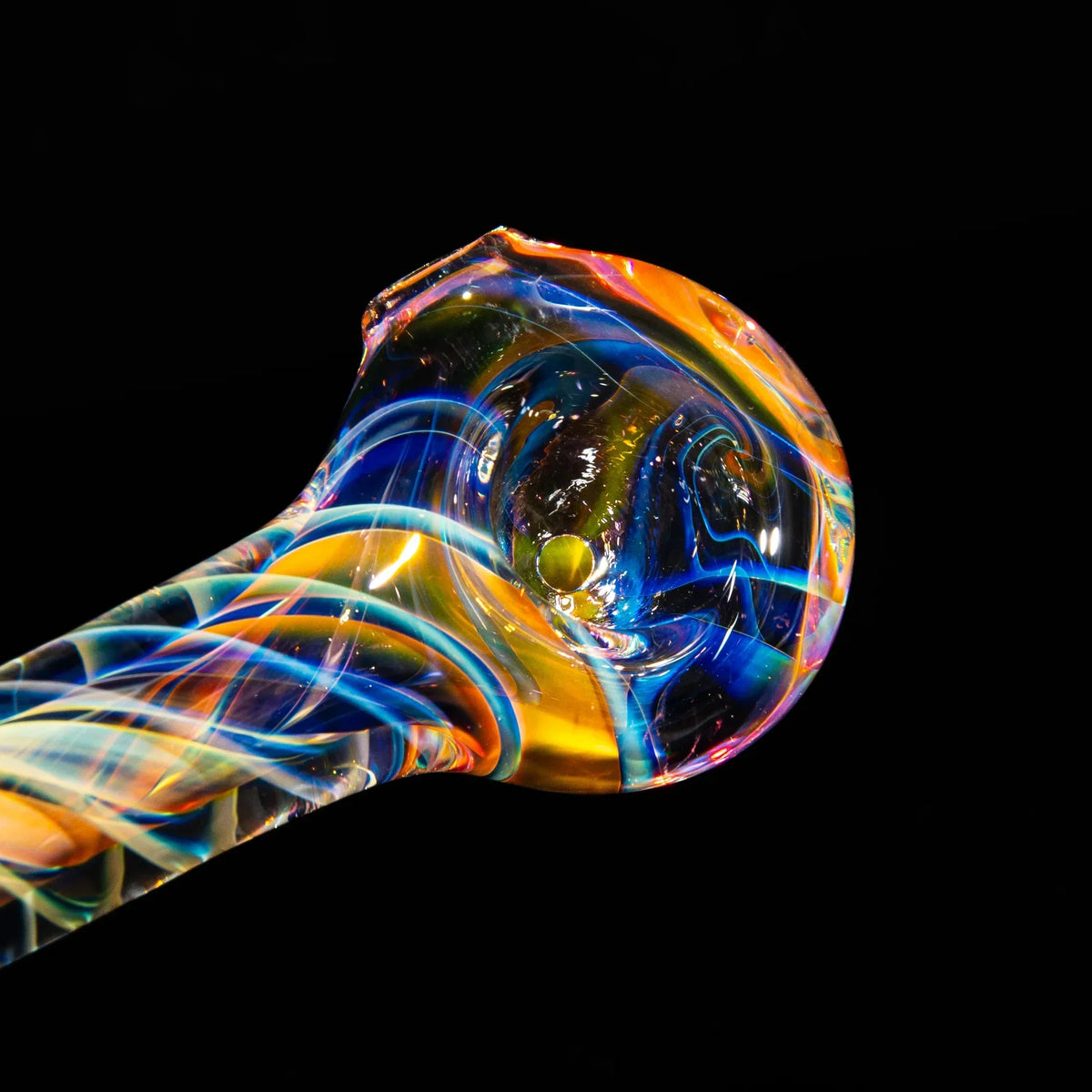 Colorful hand-blown glass smoking pipe with vibrant swirling patterns on black background