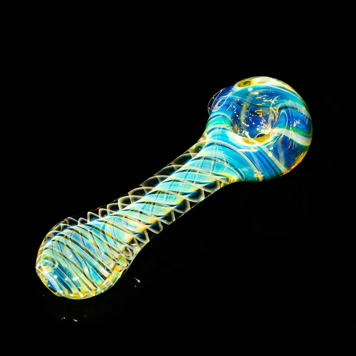 Heady glass hand pipe with blue and yellow swirls on black background
