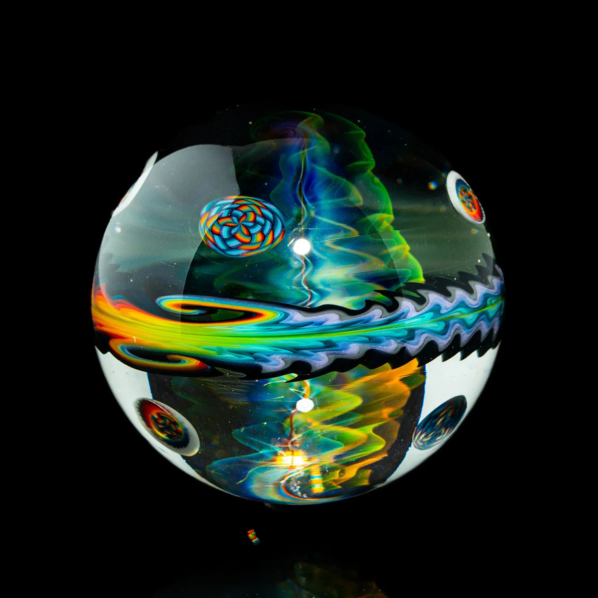 Colorful heady glass marble with intricate swirling patterns on a black background