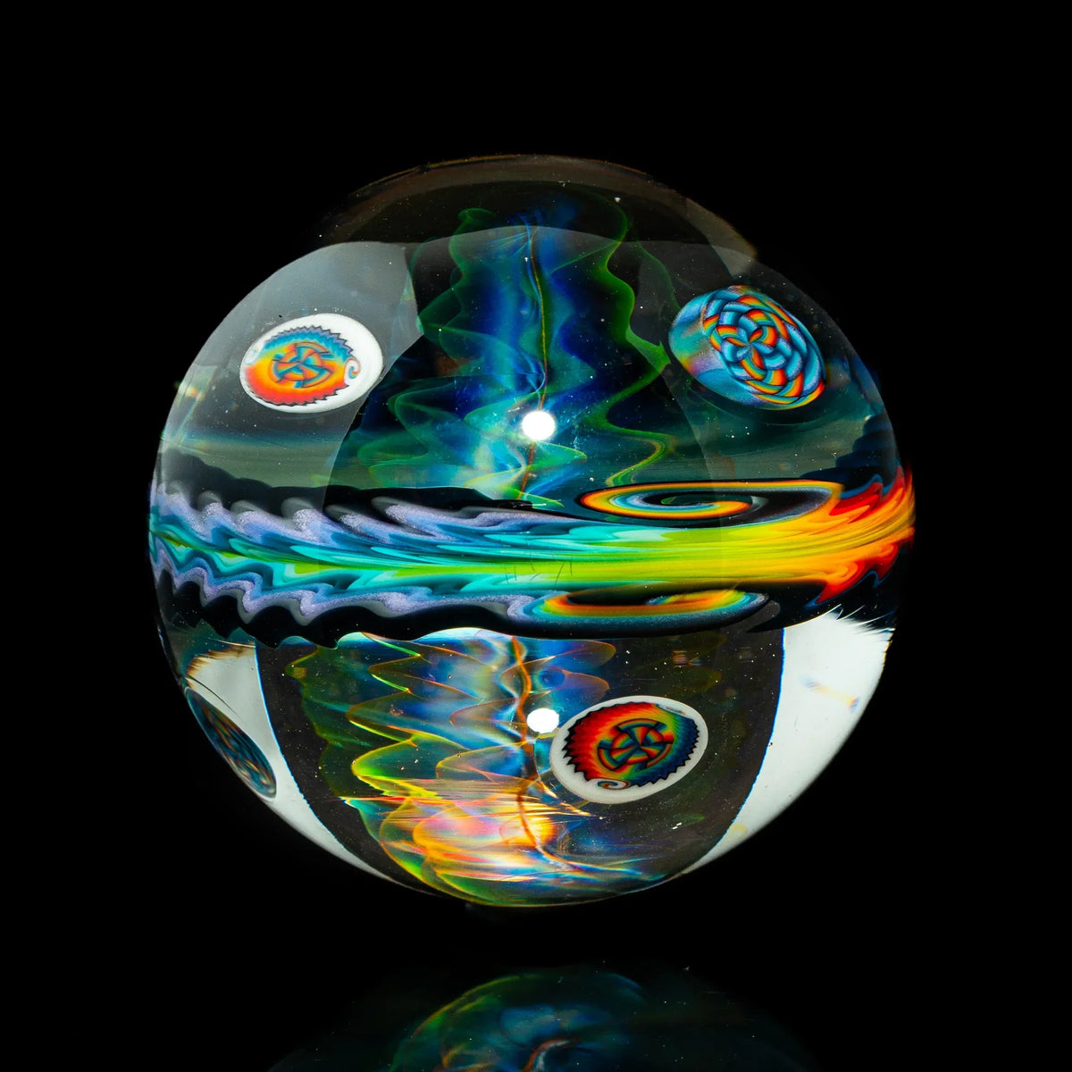 Hand-blown glass marble with vibrant rainbow swirls and intricate patterns on black background
