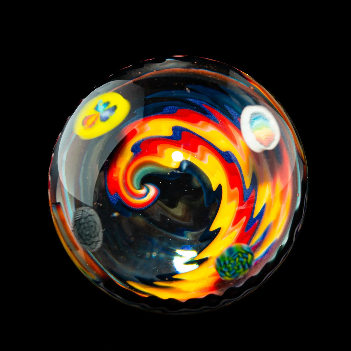 Colorful glass marble with rainbow swirl design and inset patterns on black background