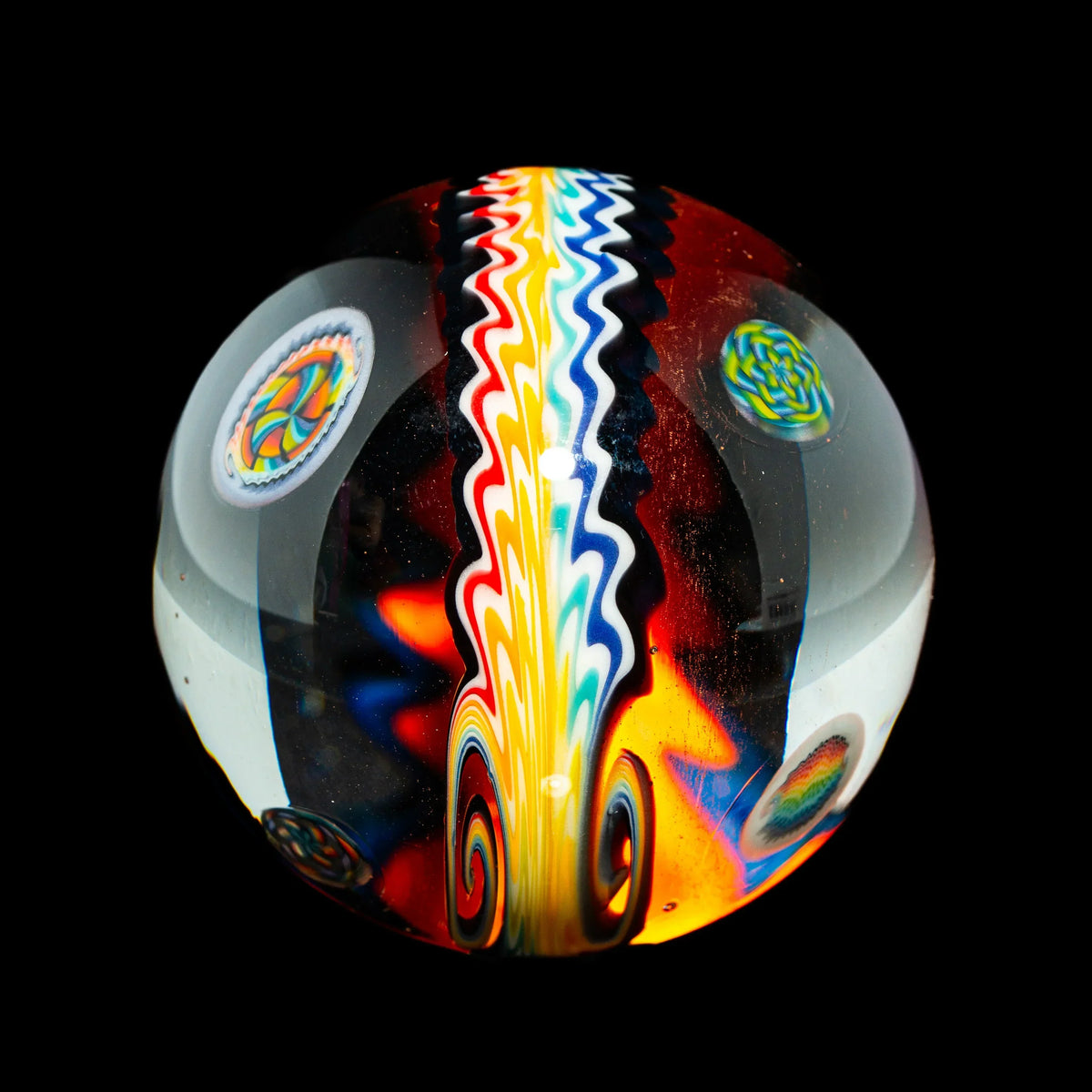 Hand-blown glass marble with vibrant rainbow wave and colorful patterns on black background.