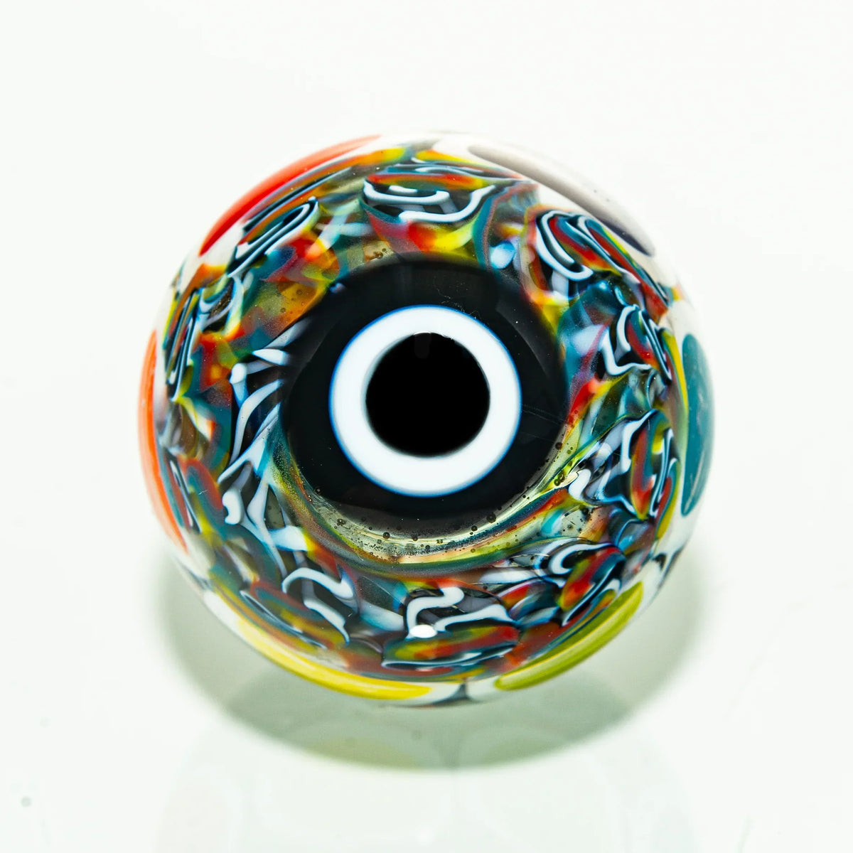 Colorful heady glass marble with psychedelic swirl patterns and a central eye design