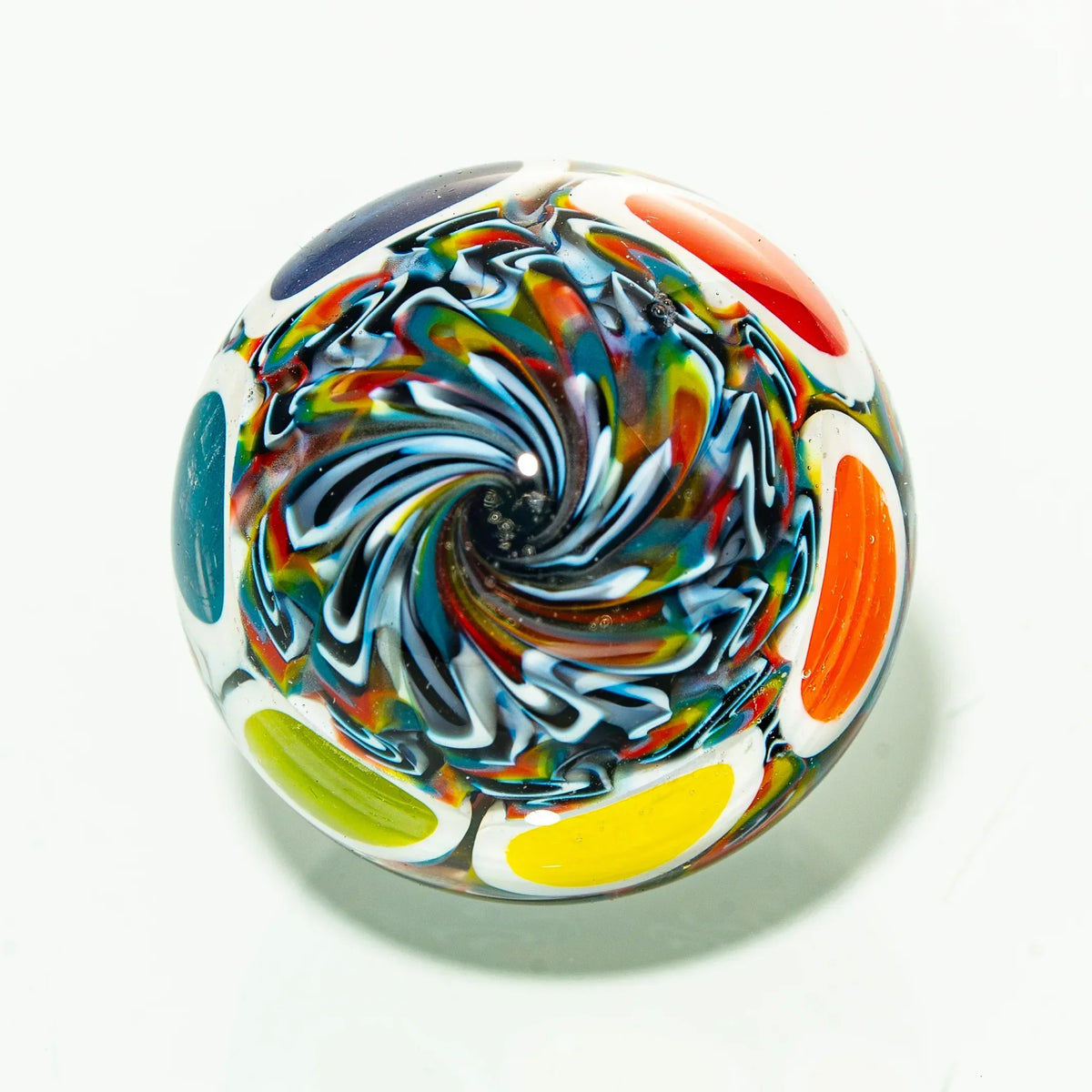 Colorful glass marble with swirl design and bold multicolor accents on white background
