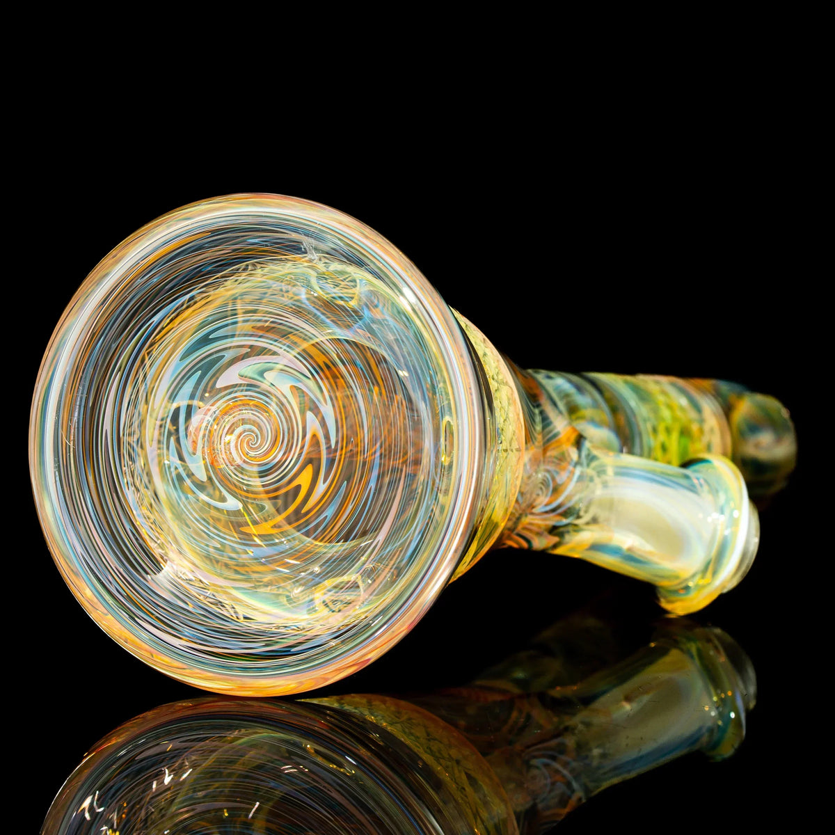 Colorful hand-blown glass pipe with intricate swirled patterns on black background