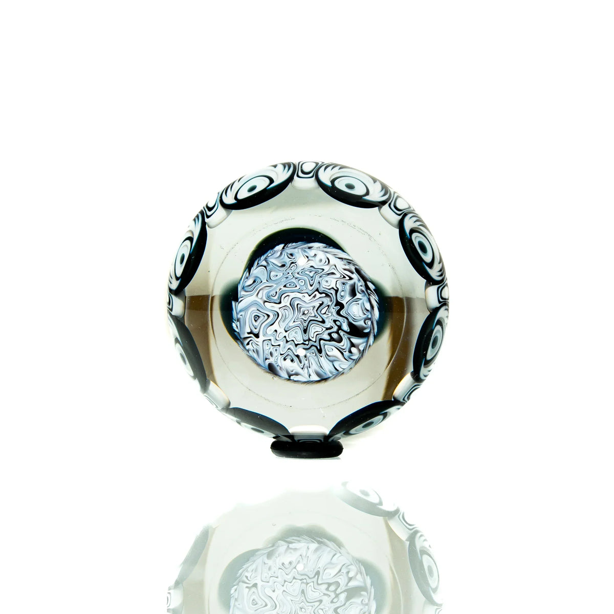 Handcrafted glass marble with black and white swirl pattern and intricate center design