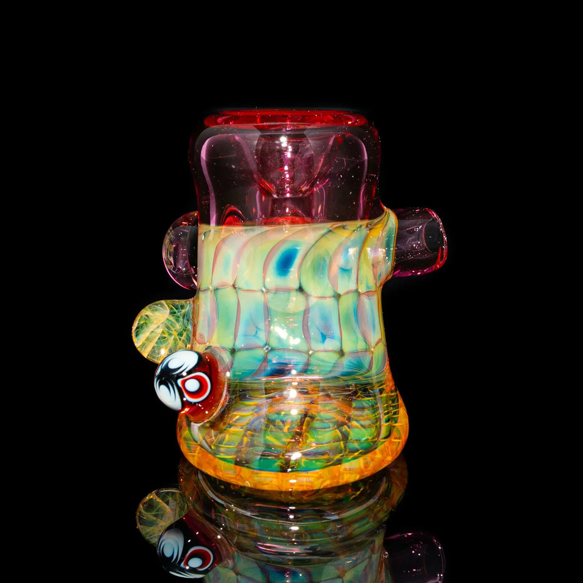 Colorful heady glass water pipe with vibrant patterns and marble accents on black background