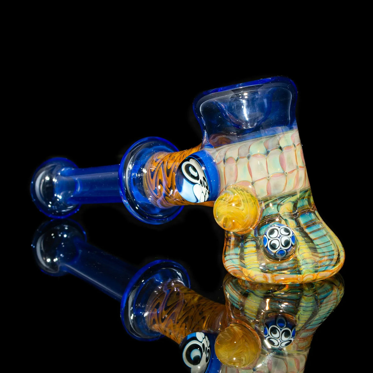 Handcrafted glass pipe with colorful patterns and intricate marbles on a black background