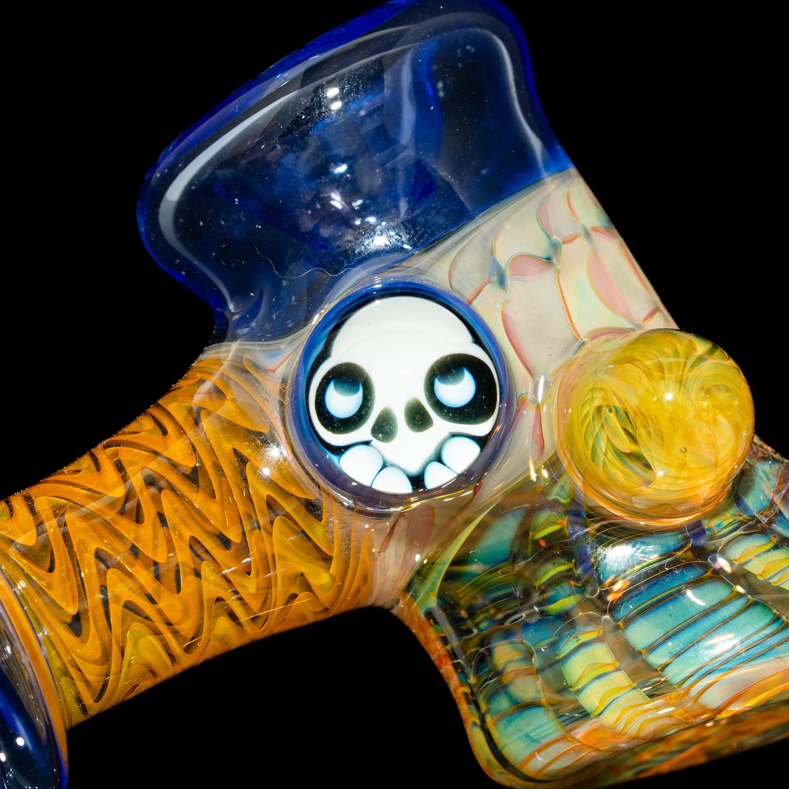 Colorful heady glass pipe with intricate patterns and a cute skull art detail