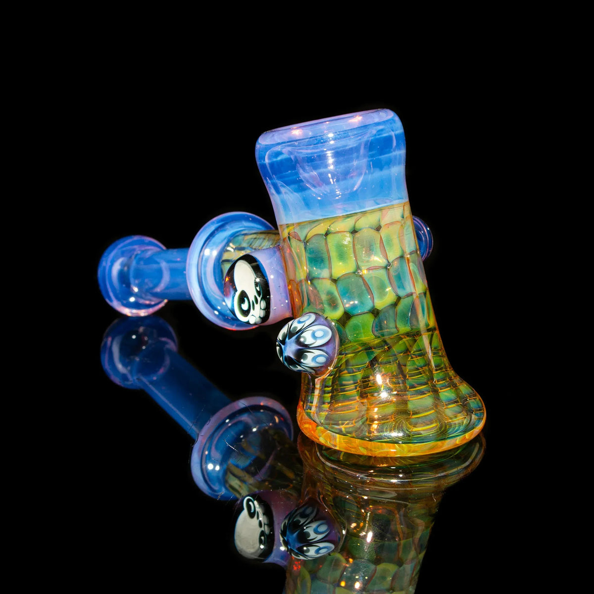 Colorful glass pipe with intricate patterns and decorative accents on black background