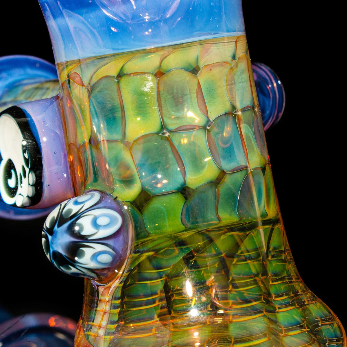 Close-up of colorful heady glass piece with honeycomb pattern and intricate marble details