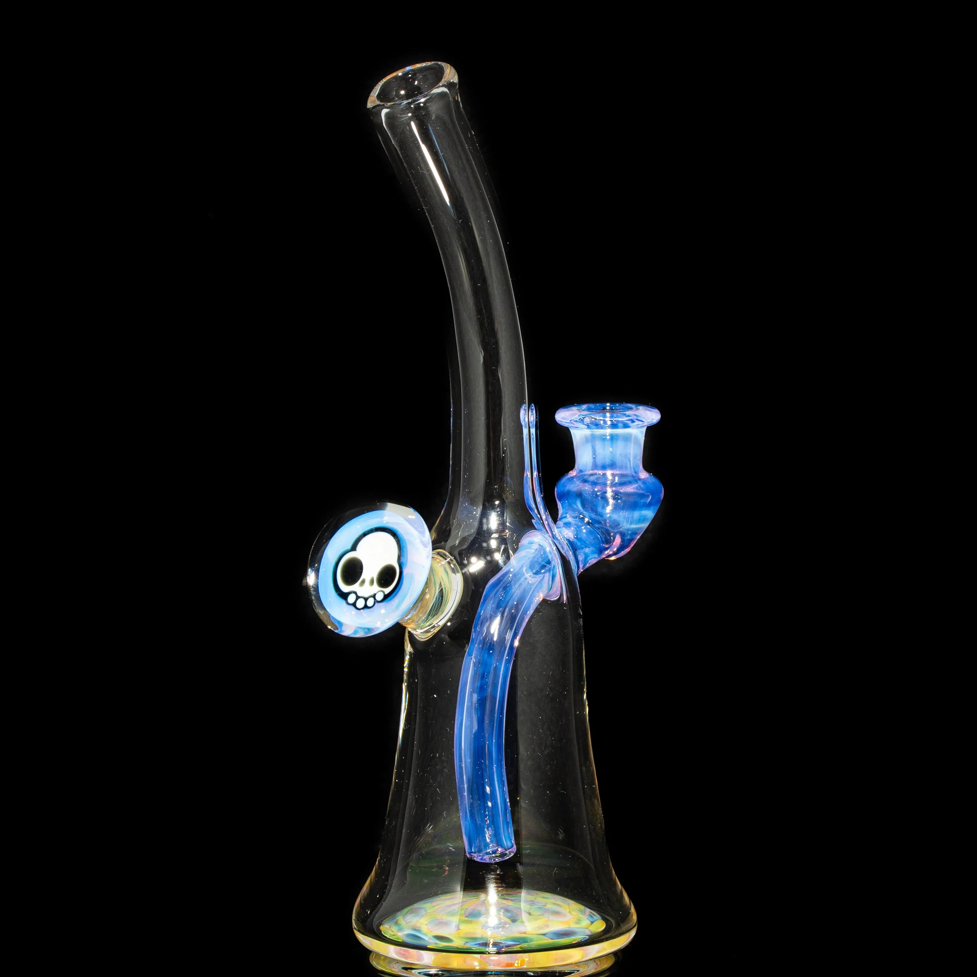 Colorful glass water pipe with blue accents and a skull design on a black background