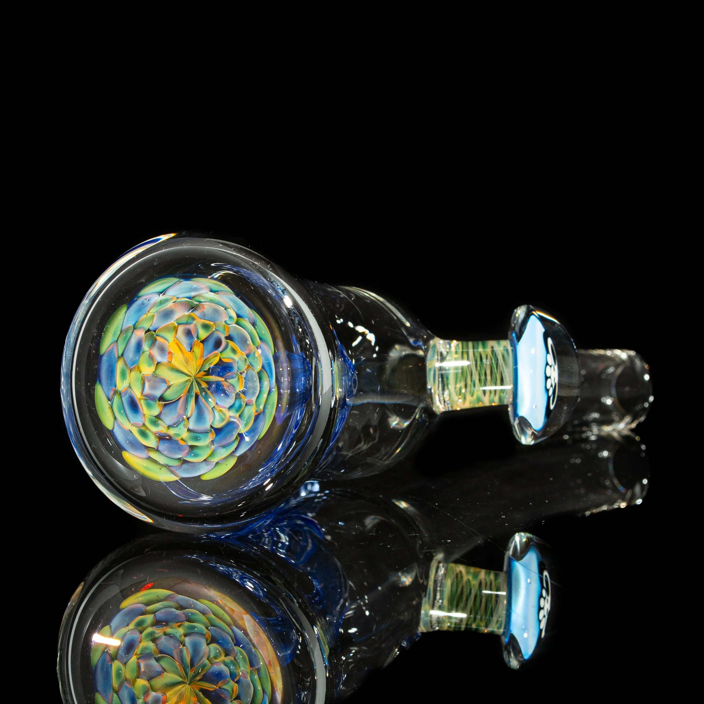 Heady glass pipe with intricate floral pattern and colorful design on a black background