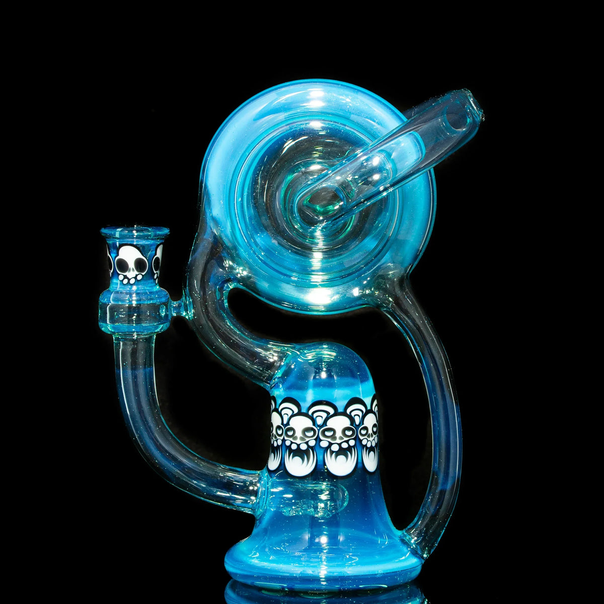Blue glass recycler water pipe with white bear skull designs, displayed on black background