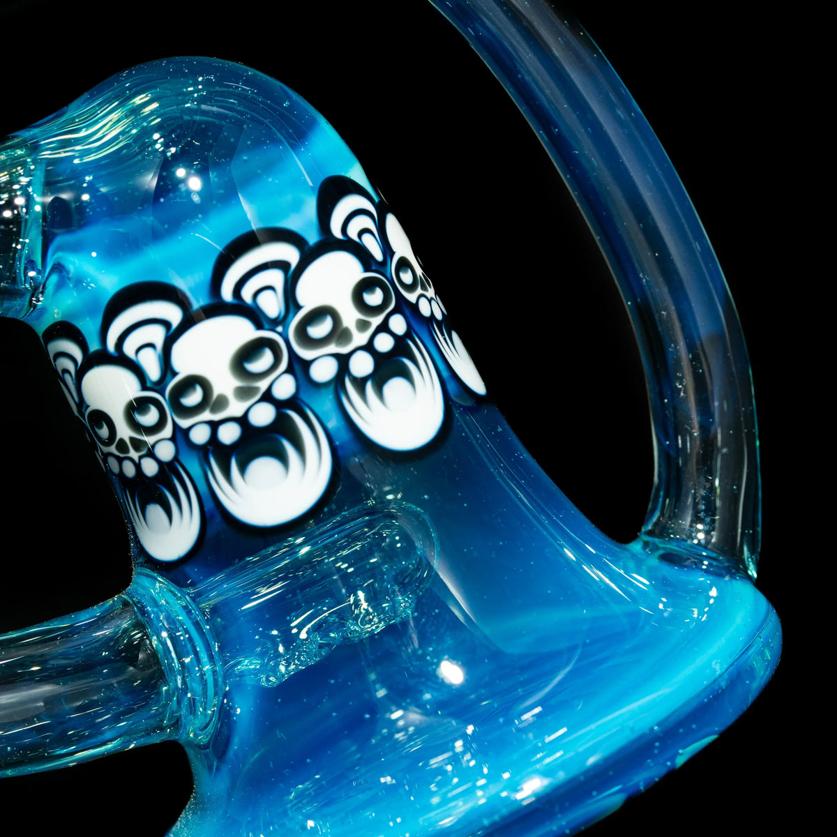 Blue glass water pipe with bear face designs, detailed heady glass art on black background