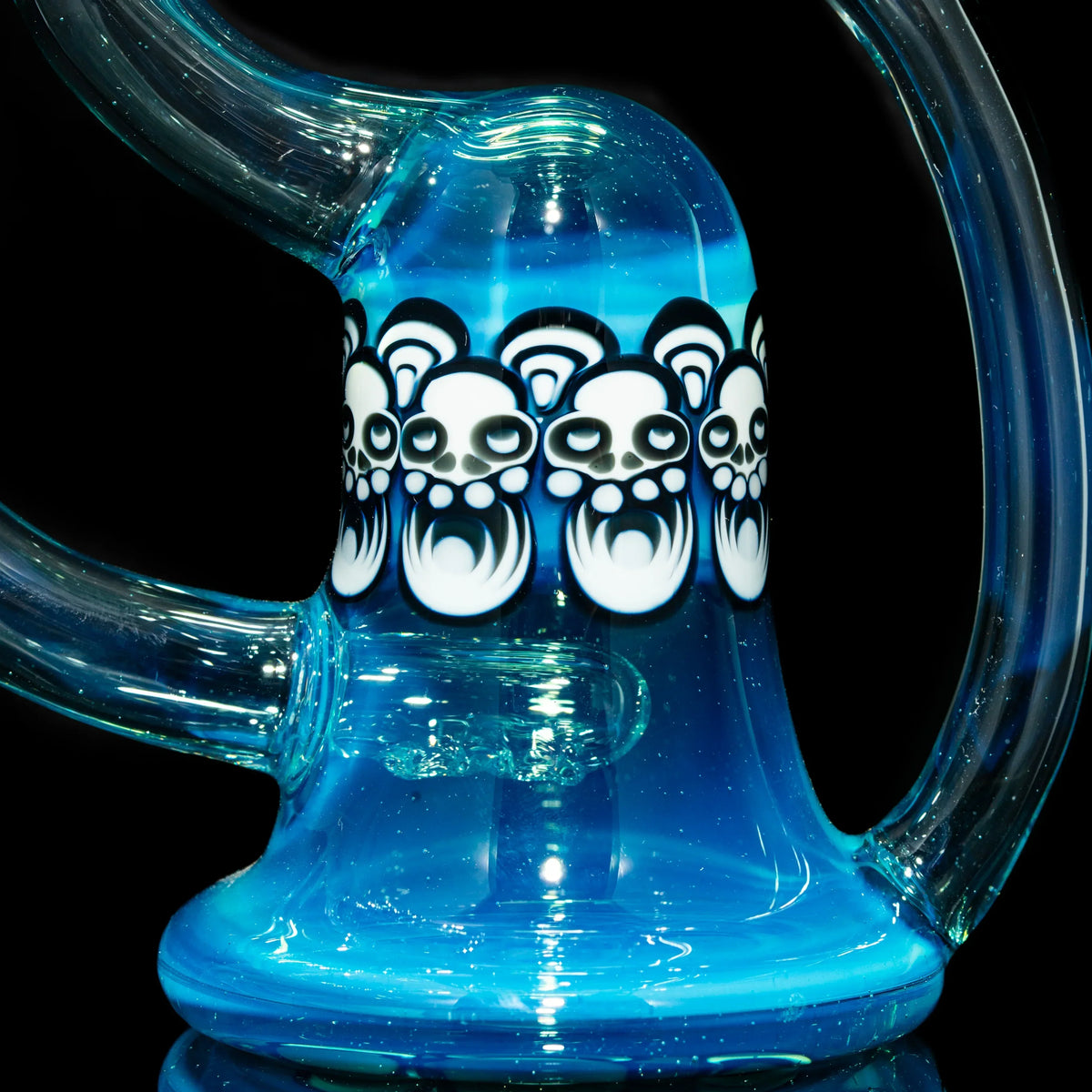 Close-up of blue glass water pipe with white skull art accents and curved clear neck