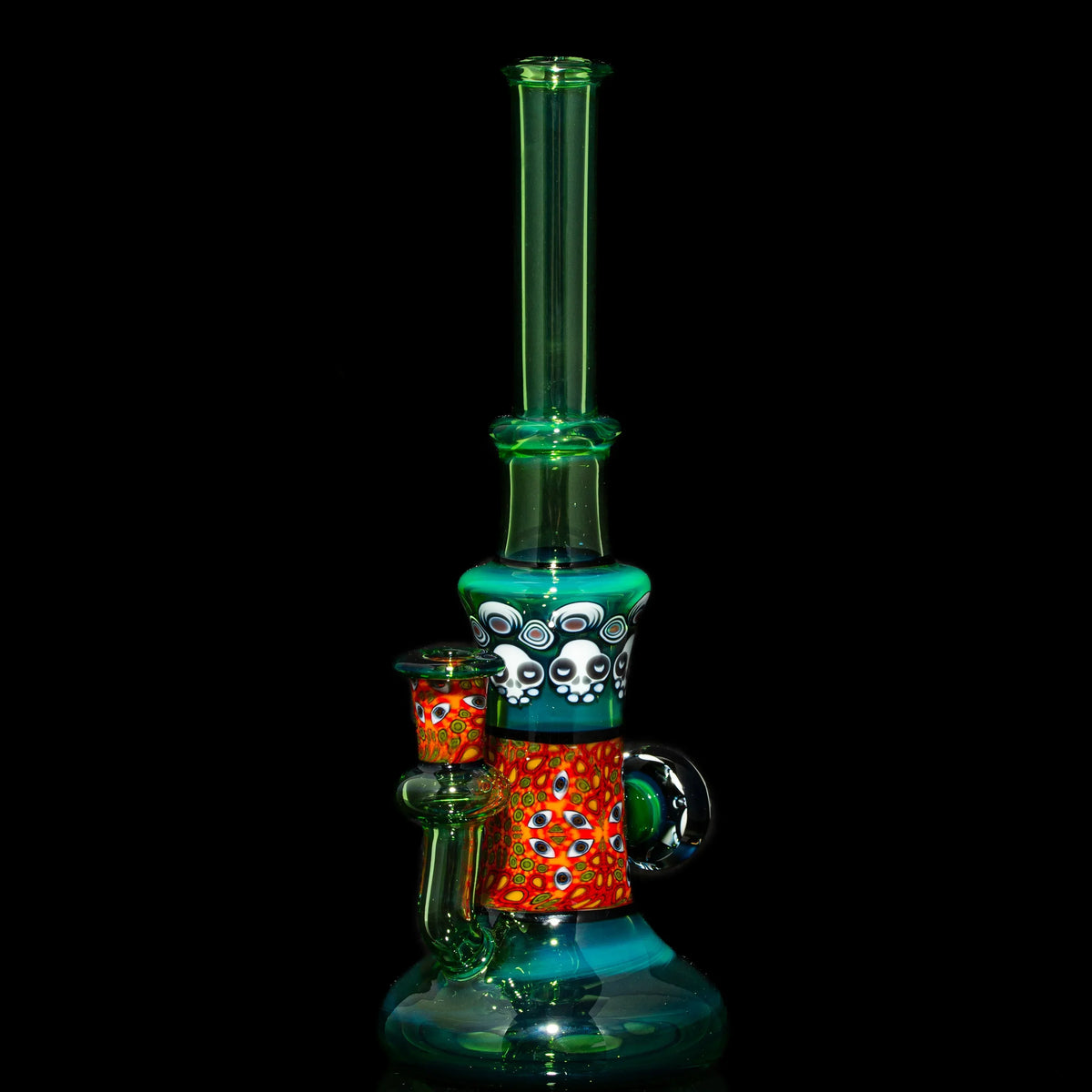 Colorful heady glass water pipe with intricate patterns and skull designs on black background